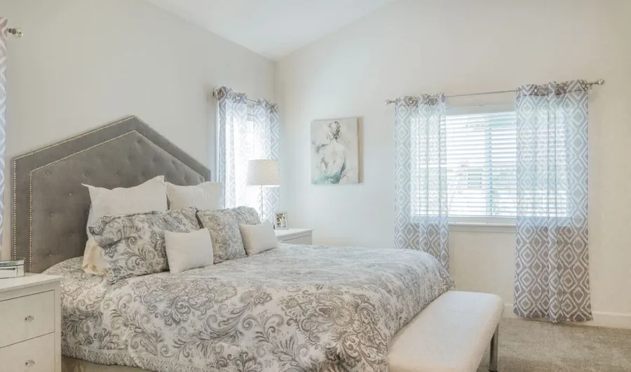Finished master bedroom with high ceilings and natural light