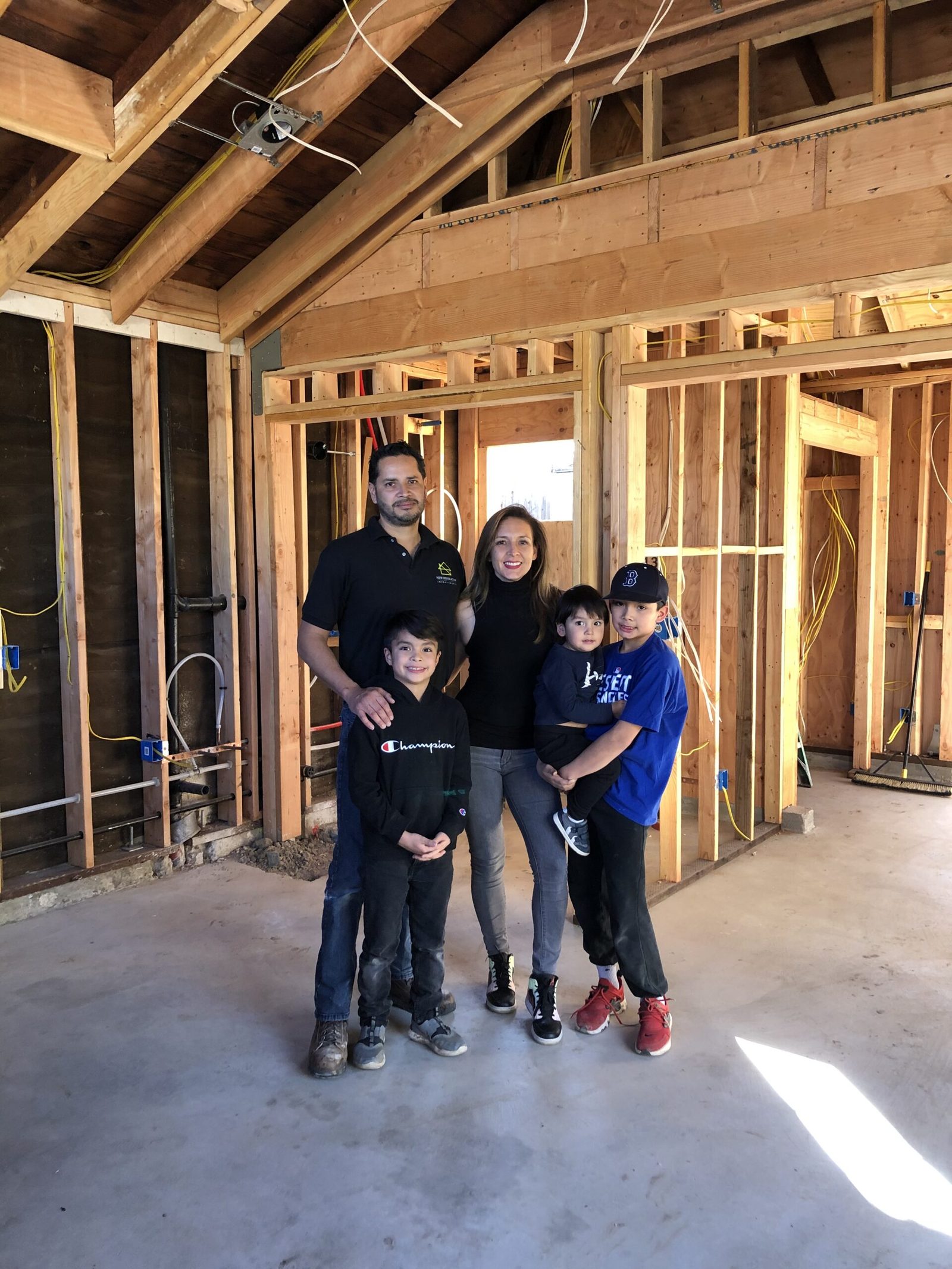 A family standing inside the framed garage conversion